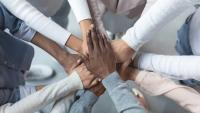 Hands connected in formation on top of one another